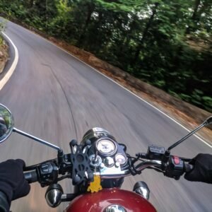 Experience the thrill of motorcycle driving on a winding forest road with speed and adventure.