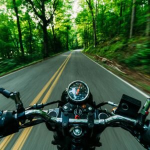 Experience the thrill of a motorcycle ride through a scenic, winding forest road. Feel the speed and freedom.